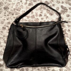 NWOT black purse with gold zippers on both sides and top
